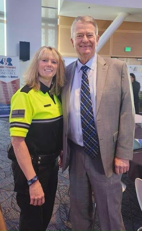 Security professional with Governor Brad Little providing VIP protection at a small business award ceremony.