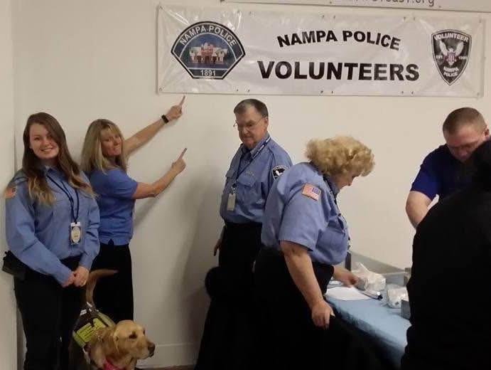 Volunteer security staff working with Nampa Police Department to manage crowd safety at a community event.